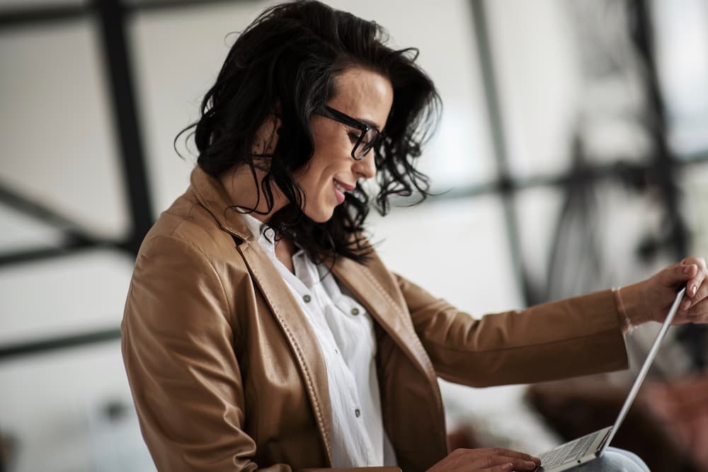 An employee working on her laptop while applying a career growth hack.