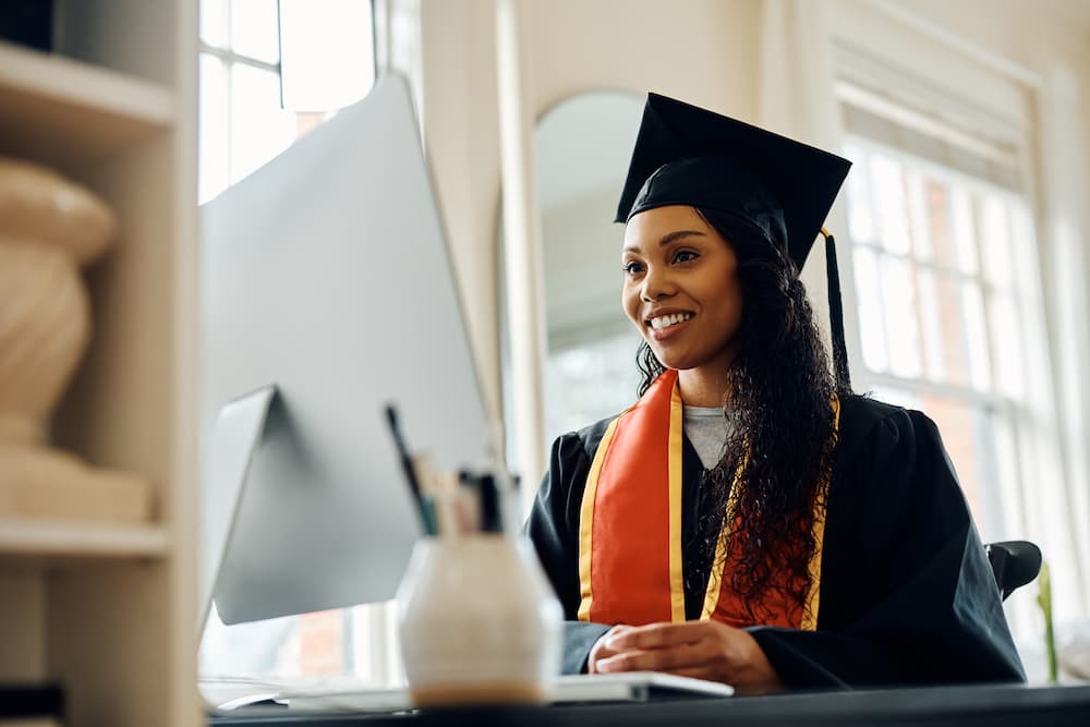 A new graduate starting a job hunt using her computer.